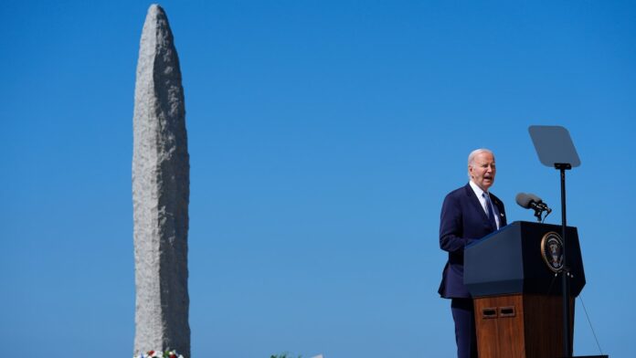 Biden defends democracy in France, drawing implied contrast with Trump